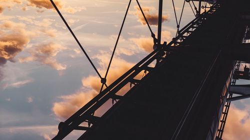 Low angle view of silhouette bridge against sky during sunset