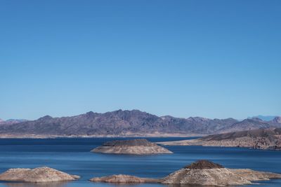 Scenic view of mountains against clear blue sky