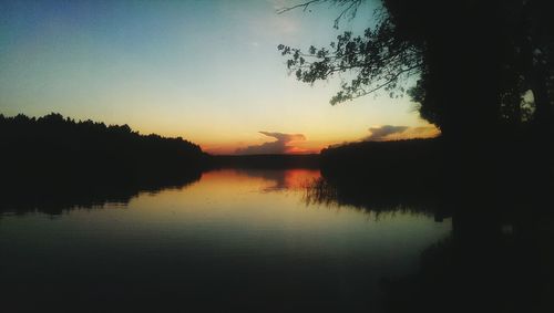 Scenic shot of calm lake at sunset