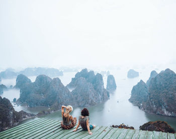 People on mountain against sky