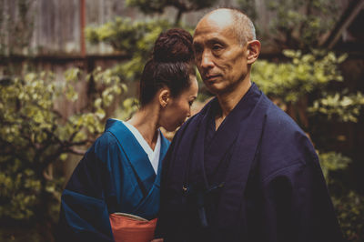 Portrait of young couple kissing outdoors