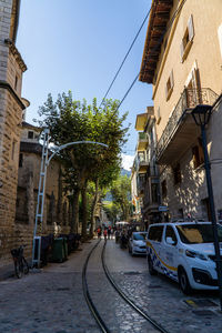 Street amidst buildings in city against sky