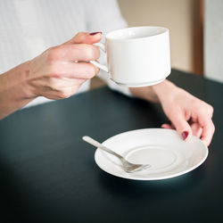 Morning cup of tea in the hands of a young woman