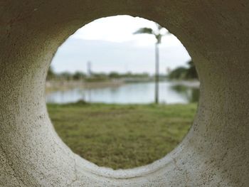 Scenic view of river seen through hole