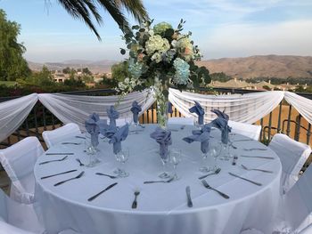 Panoramic view of white and chairs on table against sky