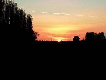 Silhouette trees against sky during sunset