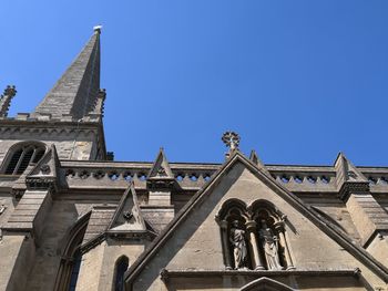 Low angle view of statues on building against clear sky