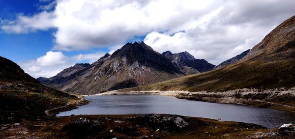 Scenic view of lake and mountains against sky