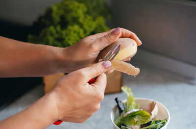 Cropped hand of woman holding drink