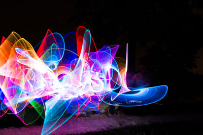 Close-up of light painting against black background