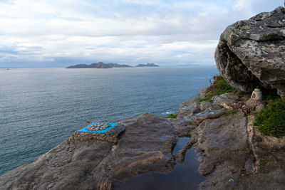 Compass rose on a cliff in monteferro - nigran with the cies islands in the background