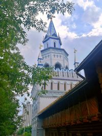 Low angle view of building and trees against sky