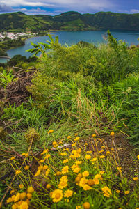 Scenic view of sea and mountains against sky