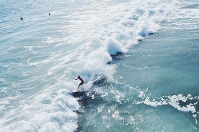 High angle view of man surfing on wave in sea