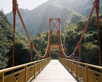 Footbridge against mountains