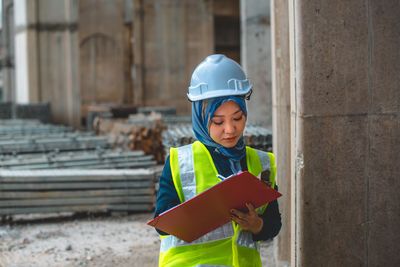 Young man standing at construction site