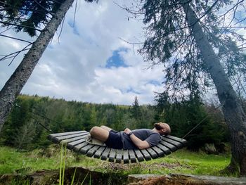 Low section of man sitting on grass