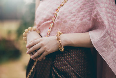 Midsection of woman wearing traditional clothing