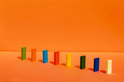 Close-up of colored pencils against orange background