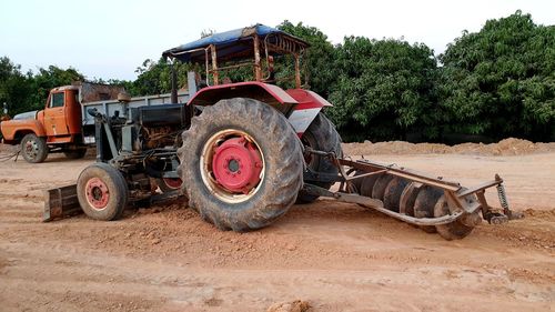 Abandoned tractor on field against sky