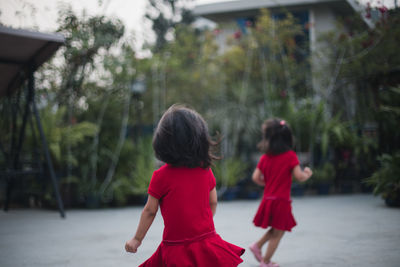 Rear view of two women walking in park