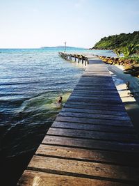 Pier over sea against clear sky