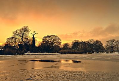 Scenic view of landscape against sky at sunset