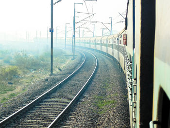 Railroad track against cloudy sky