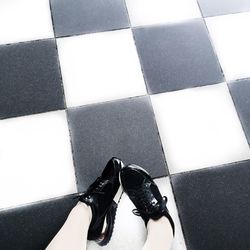 Low section of man standing on road