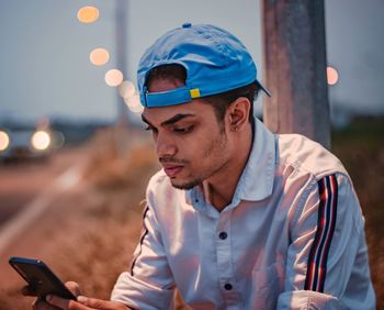 Portrait of young man using mobile phone