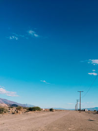 Desert road against blue sky