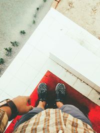 Low section of woman standing on tiled floor