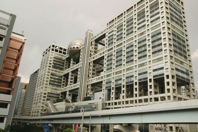 Low angle view of skyscrapers against sky in city