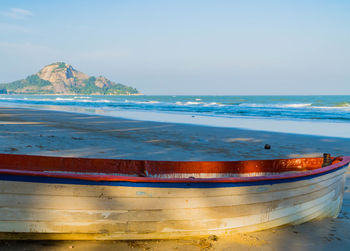 An old fishing boat on the beach with sea background. sea coast line. copy space for text.