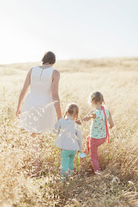 Mother with daughters in meadow