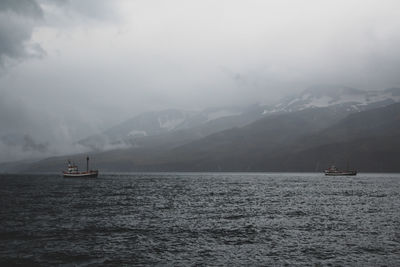Boat sailing in sea against sky