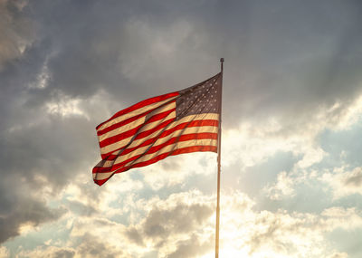 Low angle view of american flag against sky