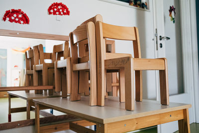 Wooden chairs on table in empty kindergarten