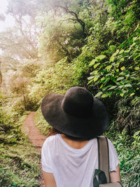 Rear view of woman wearing hat in forest