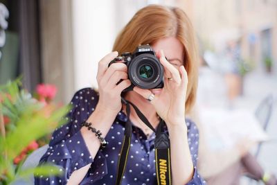 Portrait of woman photographing