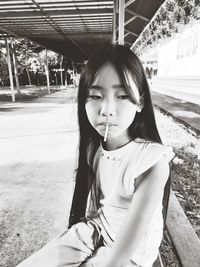 Portrait of a smiling girl sitting outdoors