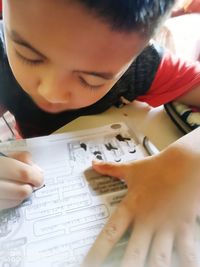 Close-up of boy holding paper