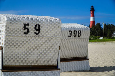 Text written on beach against sky