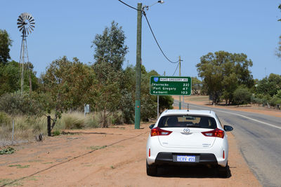 View of road sign against trees