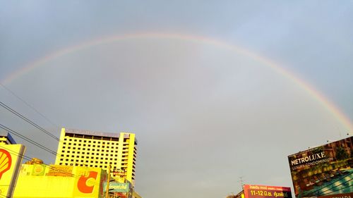 Low angle view of rainbow over buildings