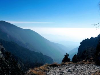 Scenic view of landscape and mountains against clear sky