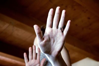 Low angle view of woman hand showing stop gesture at home