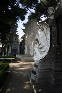 Statue outside temple against building