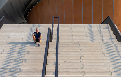 Full length of mature man sitting on steps