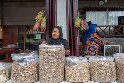 Full length of woman standing at market stall